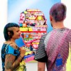 Colourful couple in front of colourful artwork 