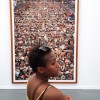 Woman Carrying red tote in front of Andreas Gursky Artwork 